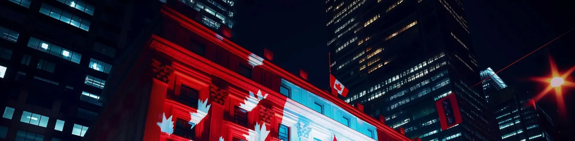 A building illuminated with a Canadian flag at night.
