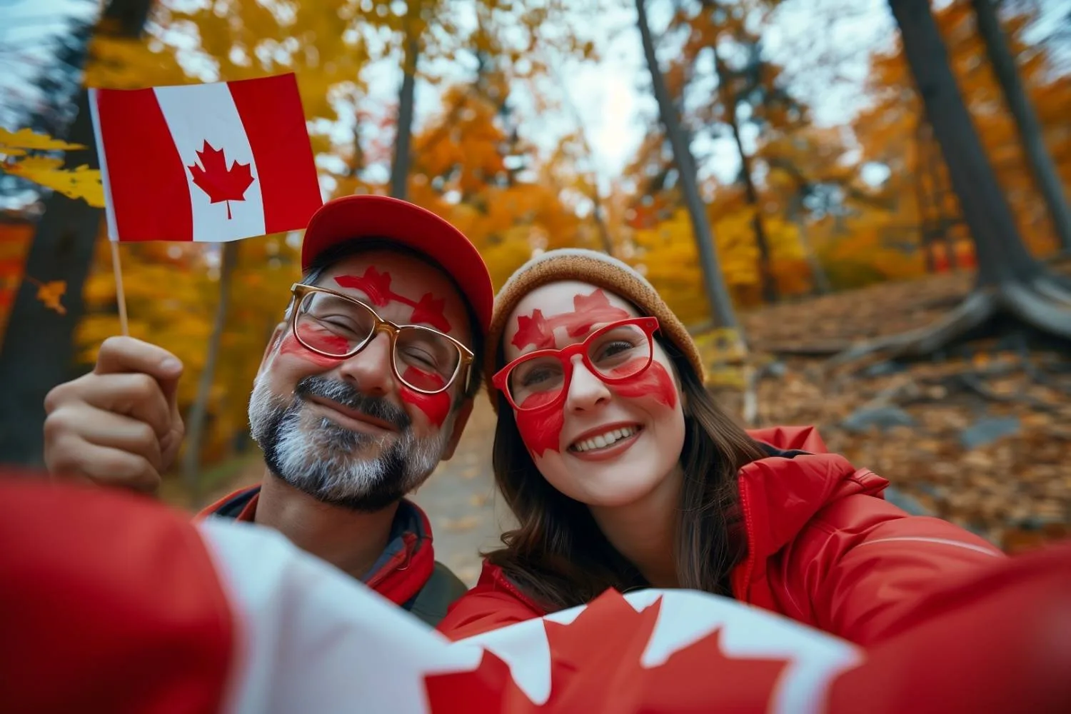 Couple celebrating Canada Day outdoors with painted faces.