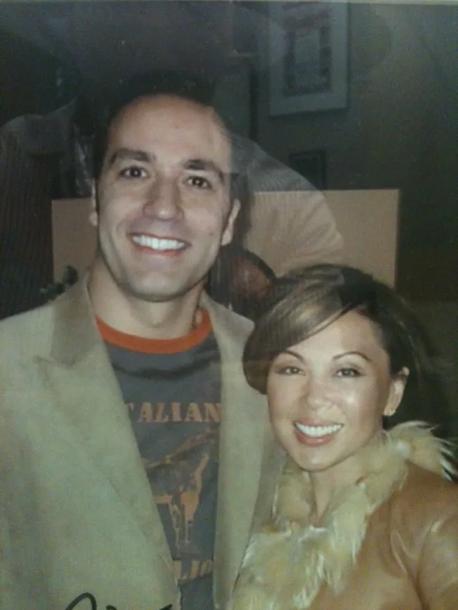 A man and a woman smiling together in a close-up photo.