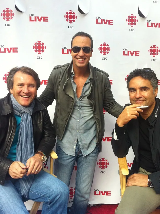 Three men at a promotional event with CBC branding.