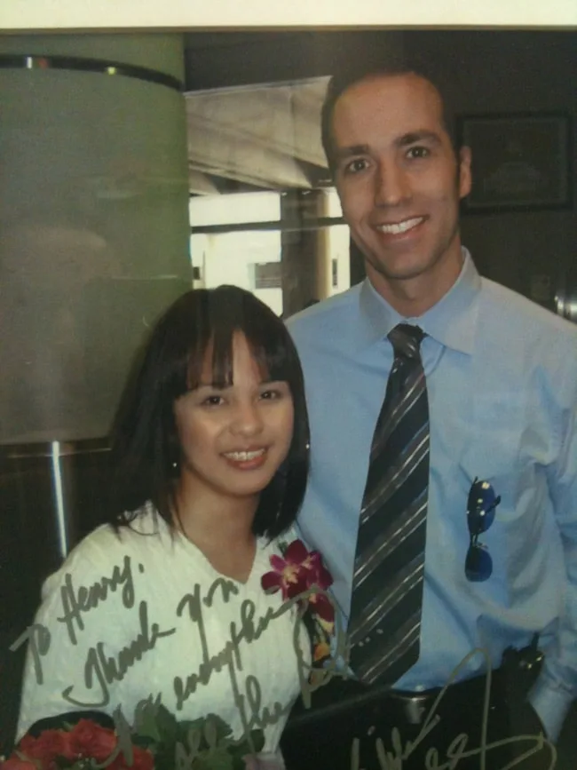 A man and a woman smiling together in a professional setting.