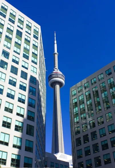 CN Tower viewed between two office buildings in Toronto.