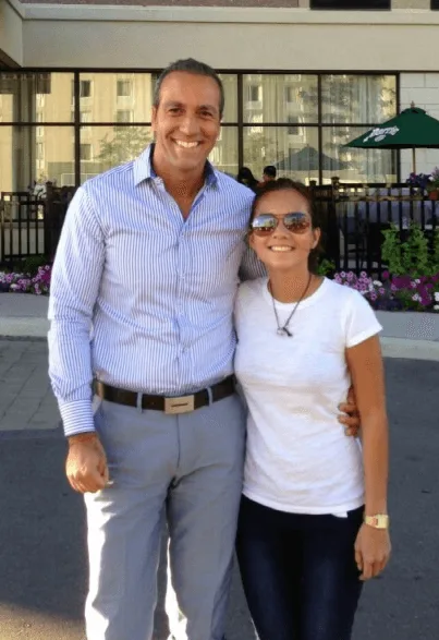 A man and woman smiling together outdoors.