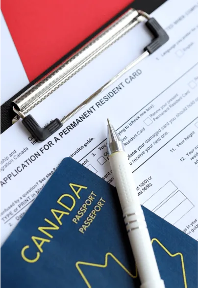 Canadian passport and immigration application form on a table.