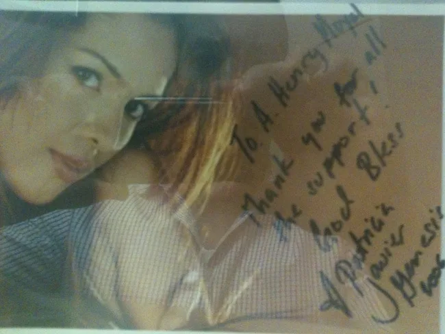 Framed photo of a smiling woman with a handwritten note.