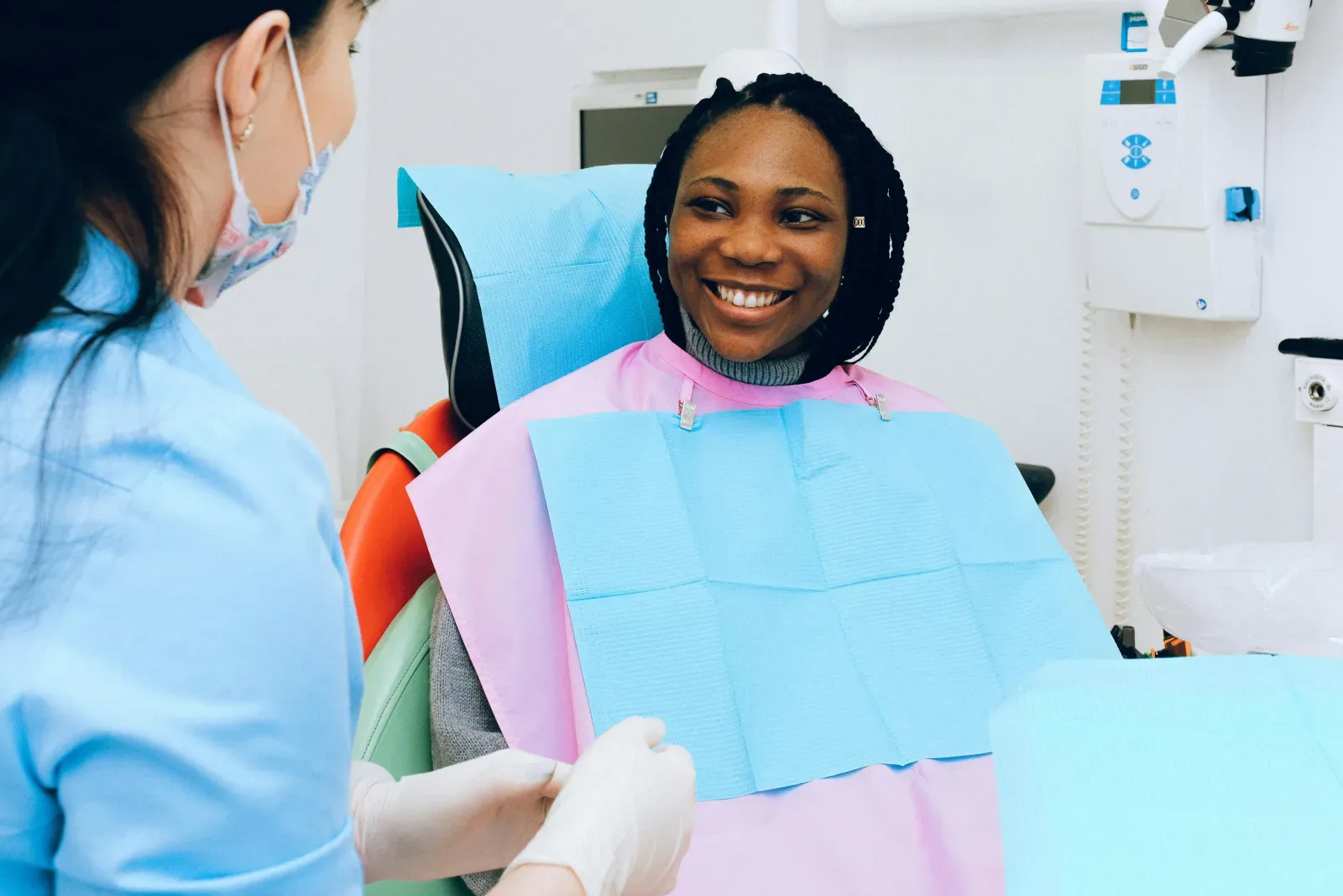 A patient smiling in a dental chair during an appointment.