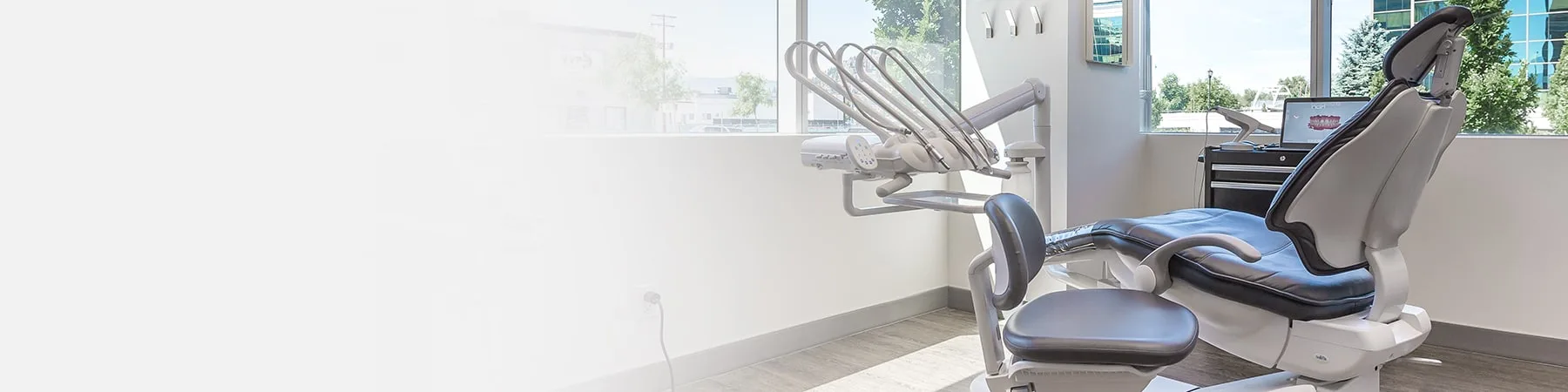 A dental treatment room with a chair and dental tools.