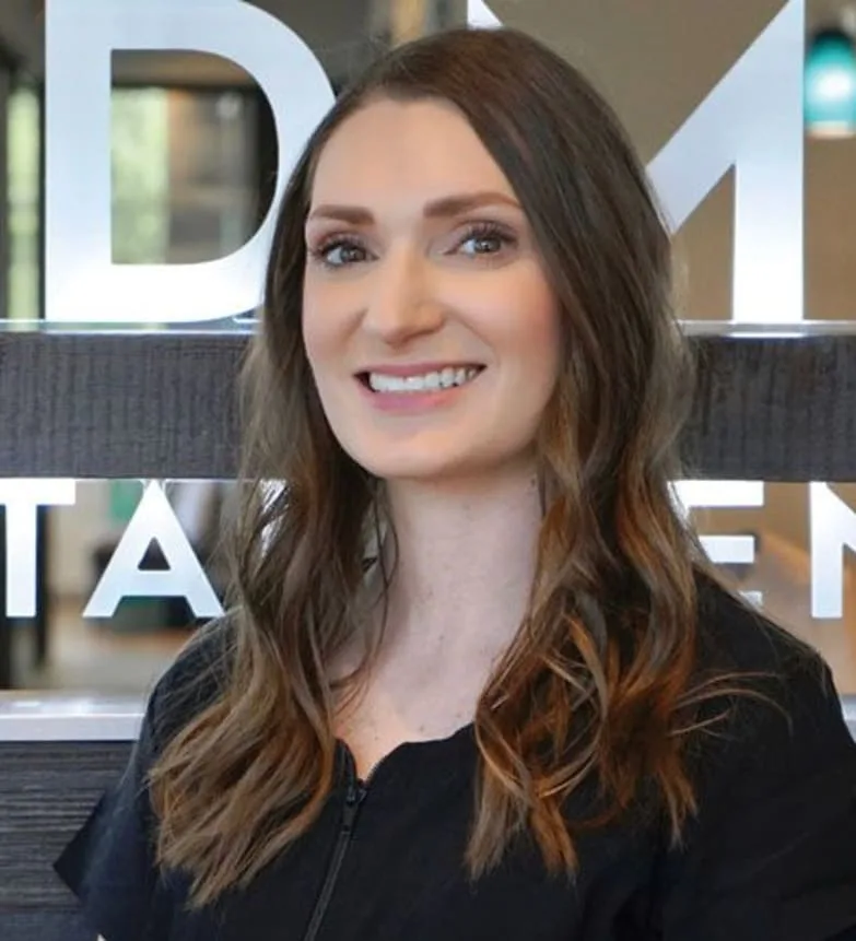 A dental professional smiling in a modern office.