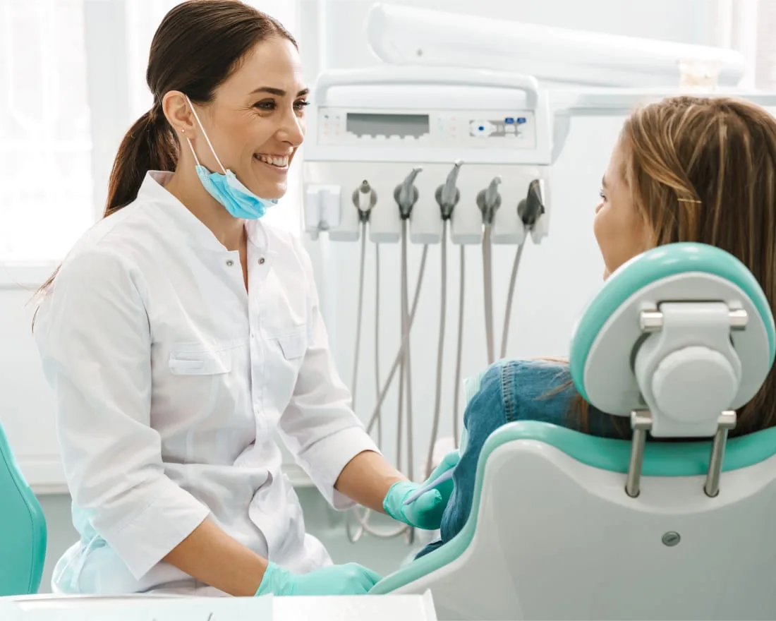 Dental hygienist engaging with a patient in a clinic setting.