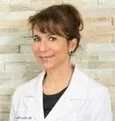 Dr. Claire Benmergui in a dental office setting.