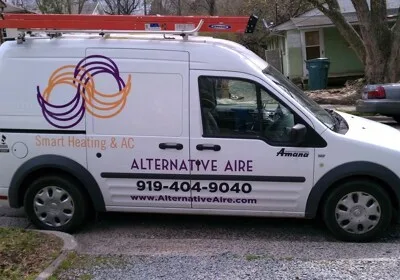 A branded HVAC service van parked in a residential area.