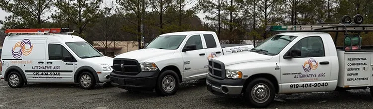 Three branded service vehicles from Alternative Aire Inc parked together.