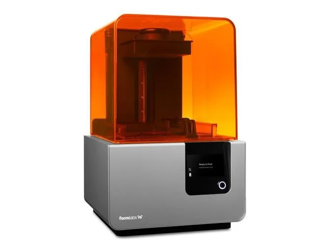 A dental 3D printer with an orange cover and silver base.