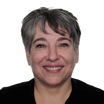 Smiling woman with short gray hair against a white background.