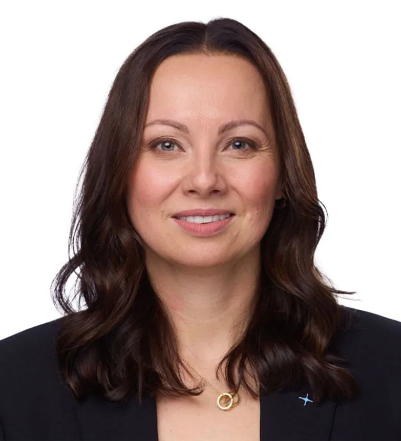 A professional woman smiling in a black blazer