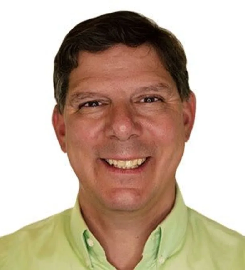A smiling man in a light green shirt.