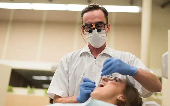 A dentist examining a patient in a dental office.