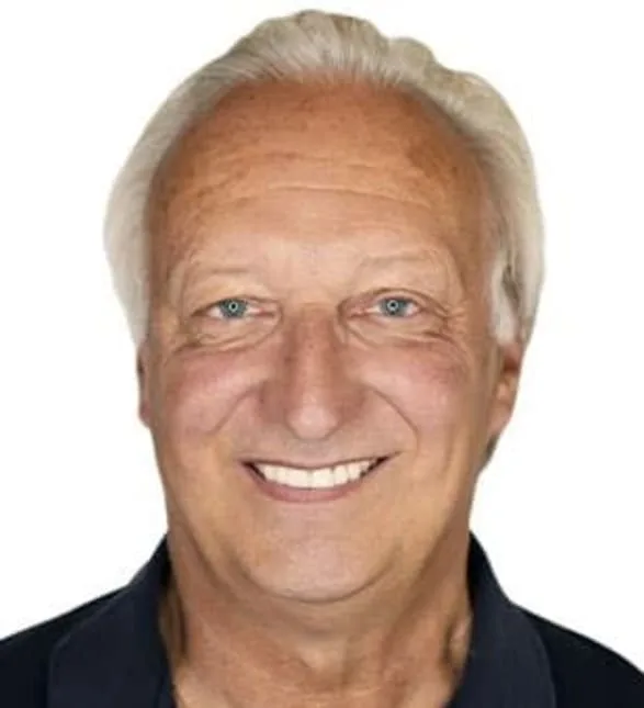 A friendly dentist smiling at the camera.