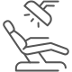 An outline of a dental chair in a reclined position.