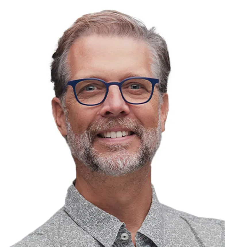 A smiling middle-aged man with glasses and a beard.