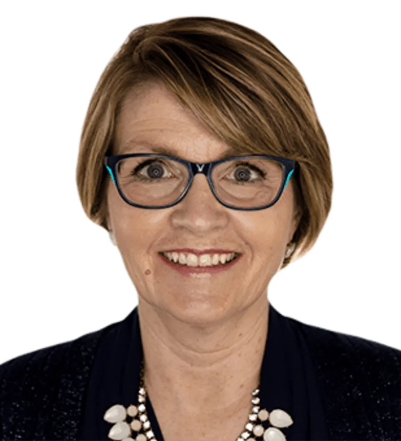 Smiling woman with glasses and a necklace against a white background.