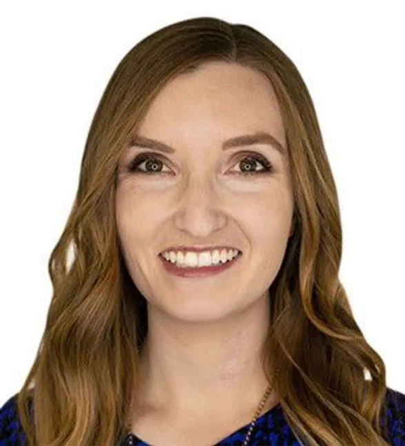 A professional woman with long brown hair smiling warmly.