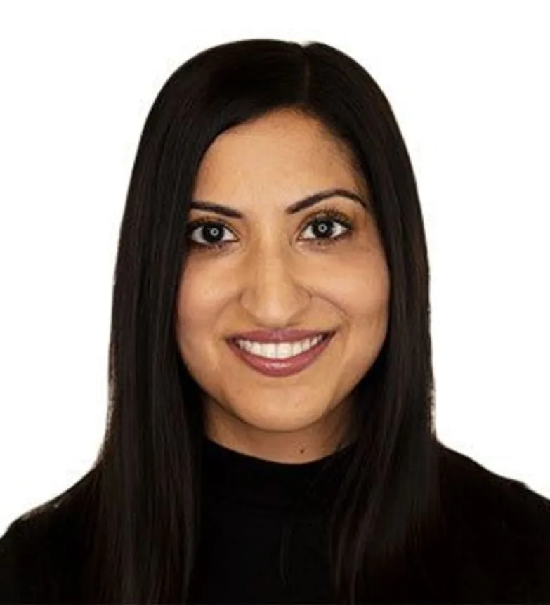 Headshot of a smiling woman in a black top.