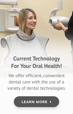 A patient in a dental chair with a dentist in a clinical setting.