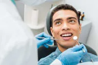 A patient smiling during a dental examination.