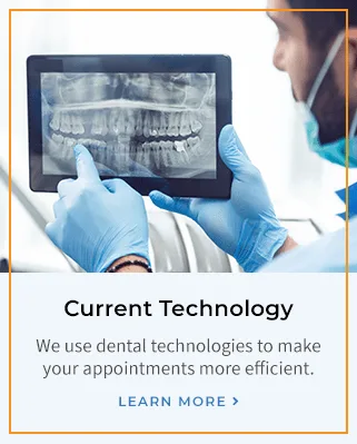 A dentist reviewing an X-ray on a tablet.