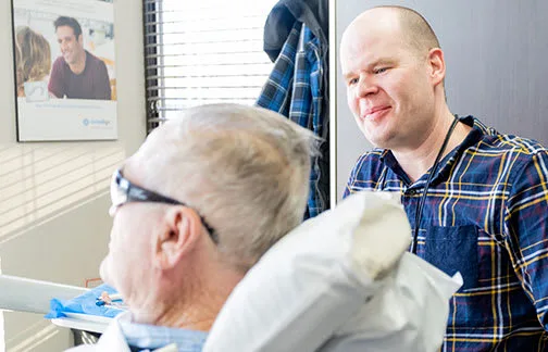 A dentist engages with a patient in a dental clinic.