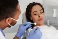 A dentist examining a patient in a dental clinic.