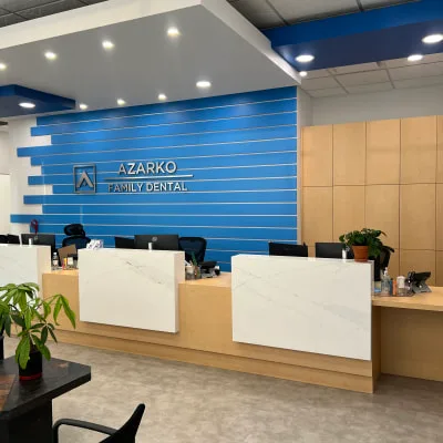 A modern dental reception area with a blue accent wall.