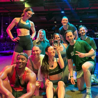 A group of fitness enthusiasts posing in a gym.