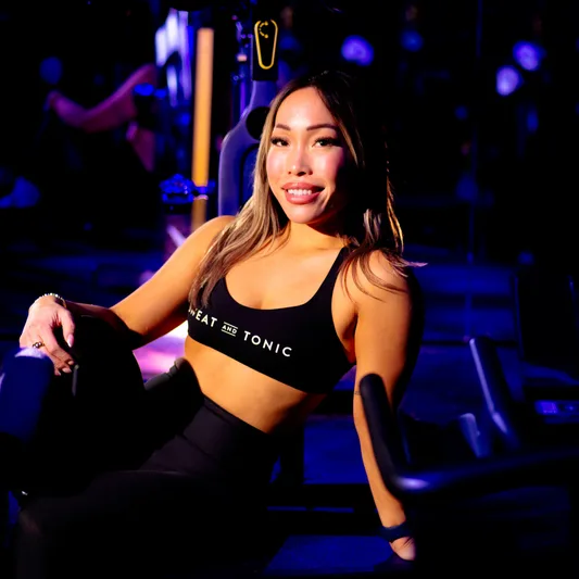 A woman in a fitness studio wearing a sports bra.