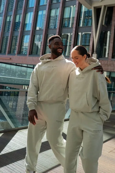 Two individuals wearing matching athletic outfits on a balcony.