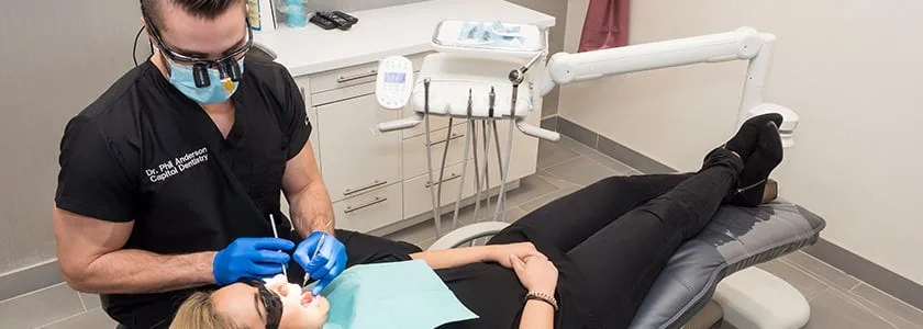 A dentist treating a patient in a dental office.