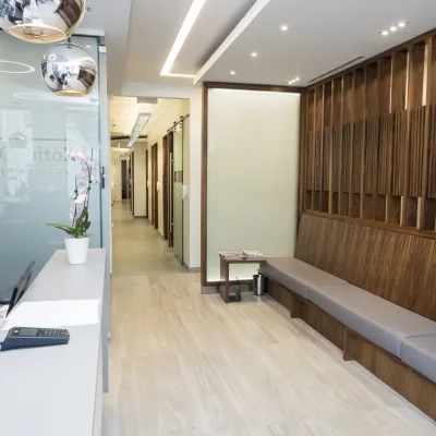 Interior of a modern dental clinic with wood paneling and seating.