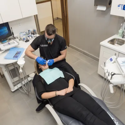A dentist treating a patient in a dental office.